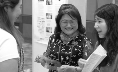Alice Chan, the CEO of The Society for AIDS Care Hong Kong, joins an employee to discuss the program. Image links to feature story 'Supporting Local Communities in the Asia Pacific Region.'