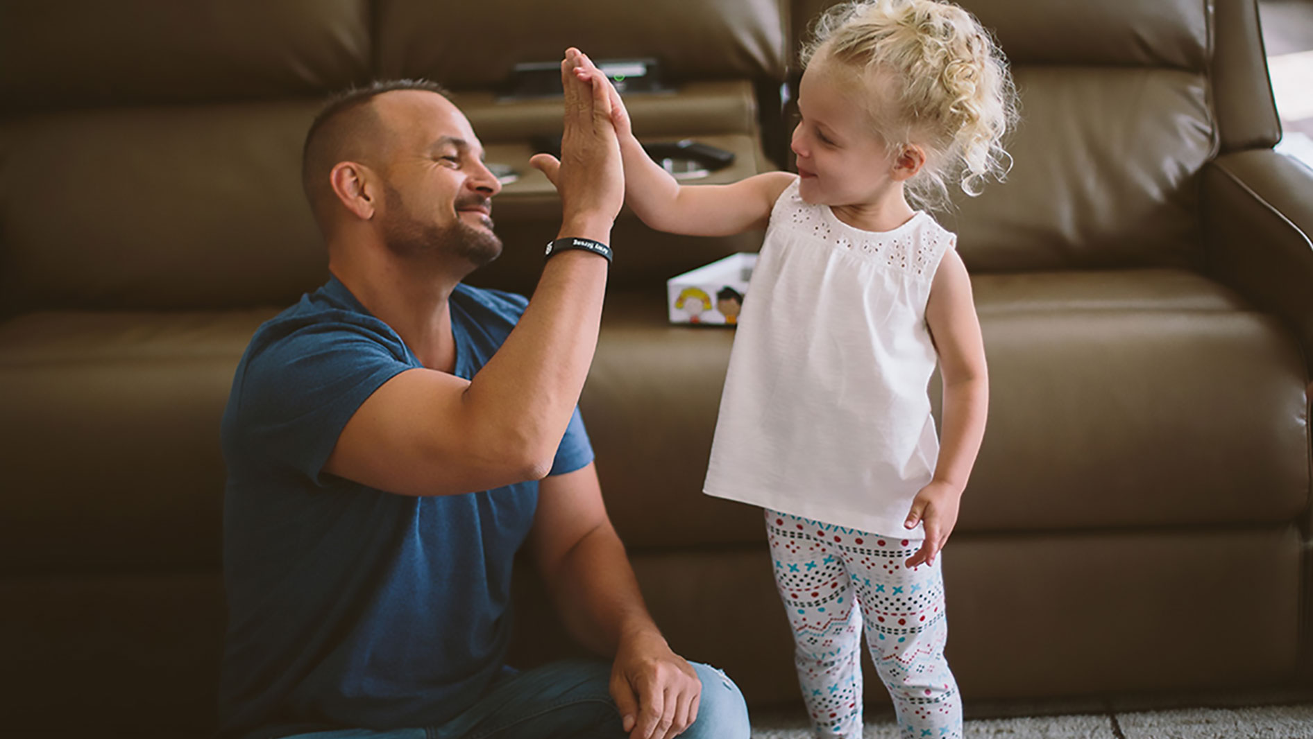 Chuck high-fiving his daughter